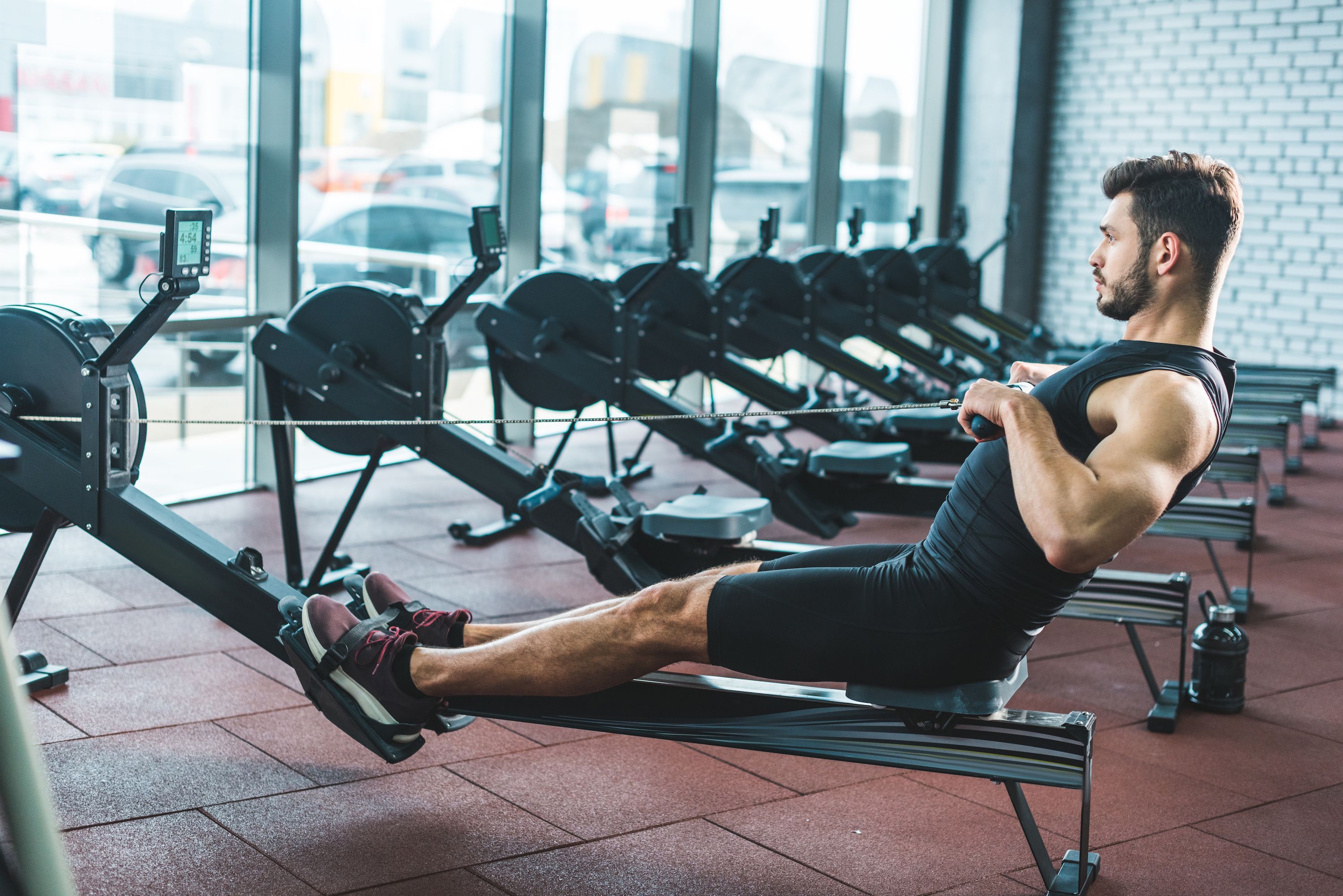 Man Using Rowing Machine 